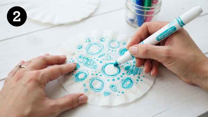 Hands drawing on coffee filter