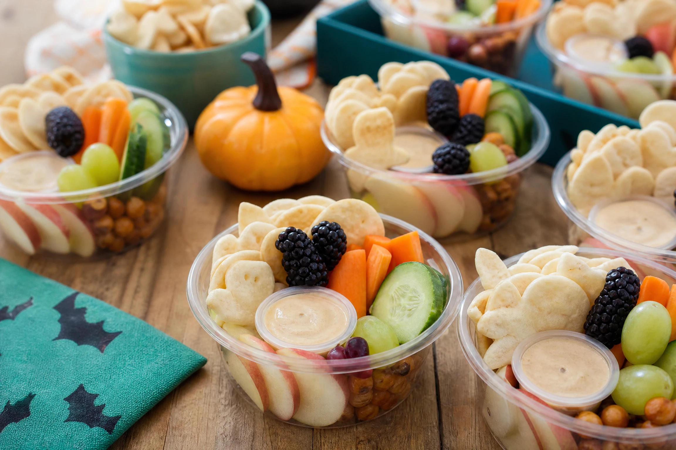 Individually portioned allergy-aware Halloween snack cups with fruit, vegetables, and crackers
