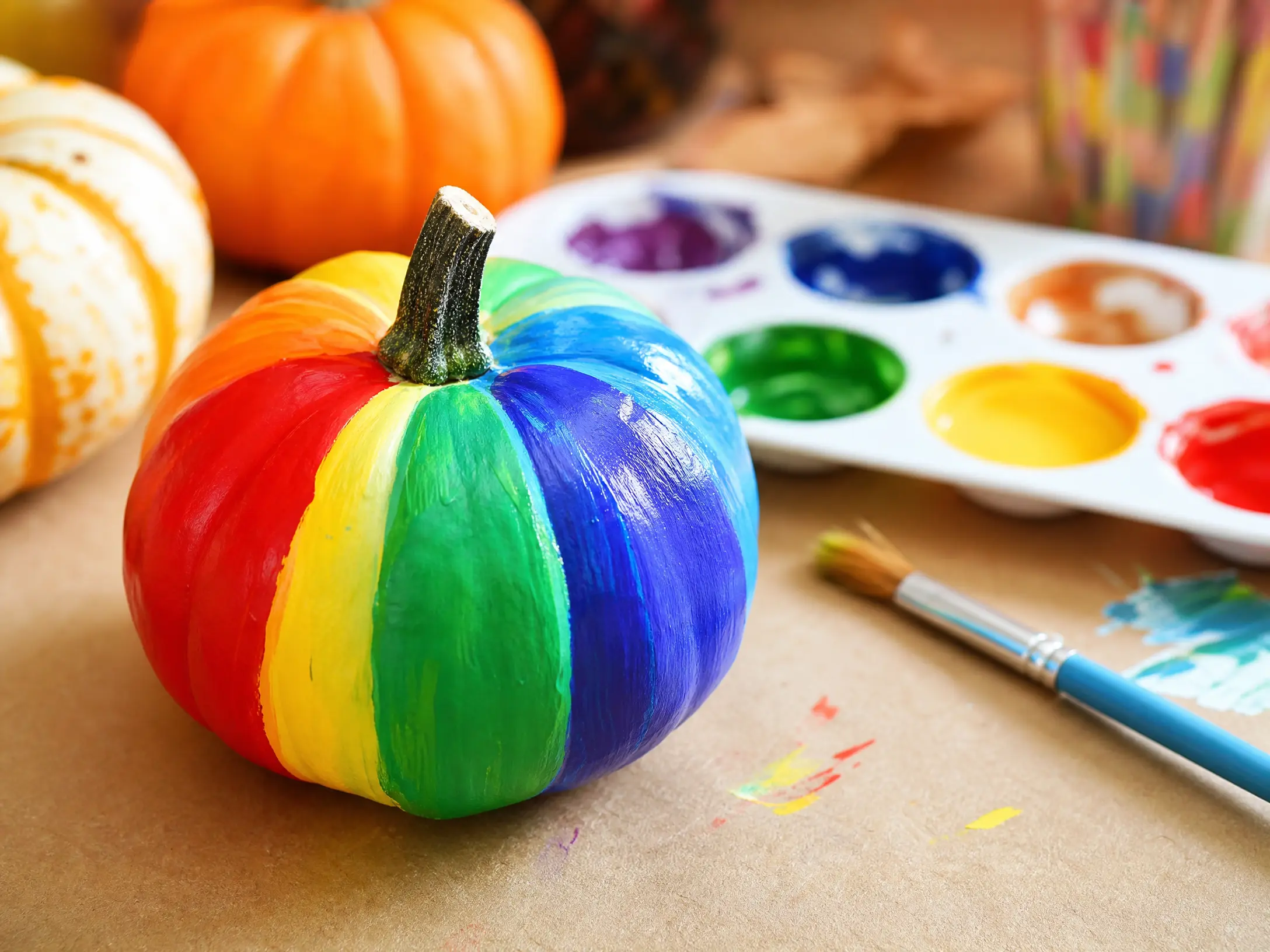 Mini pumpkin painted with colorful rainbow stripes