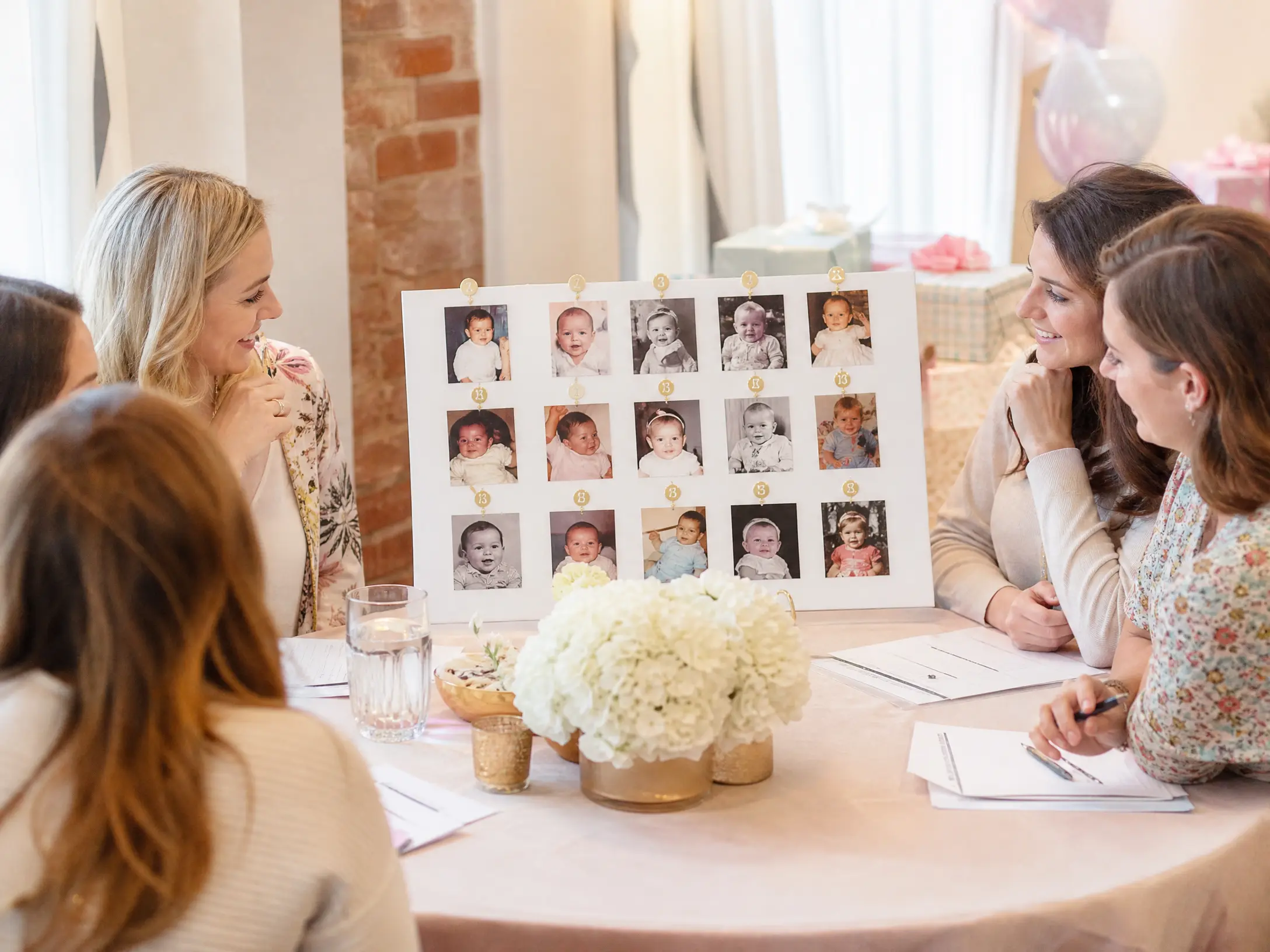 Baby shower guests matching numbered baby photos to guests