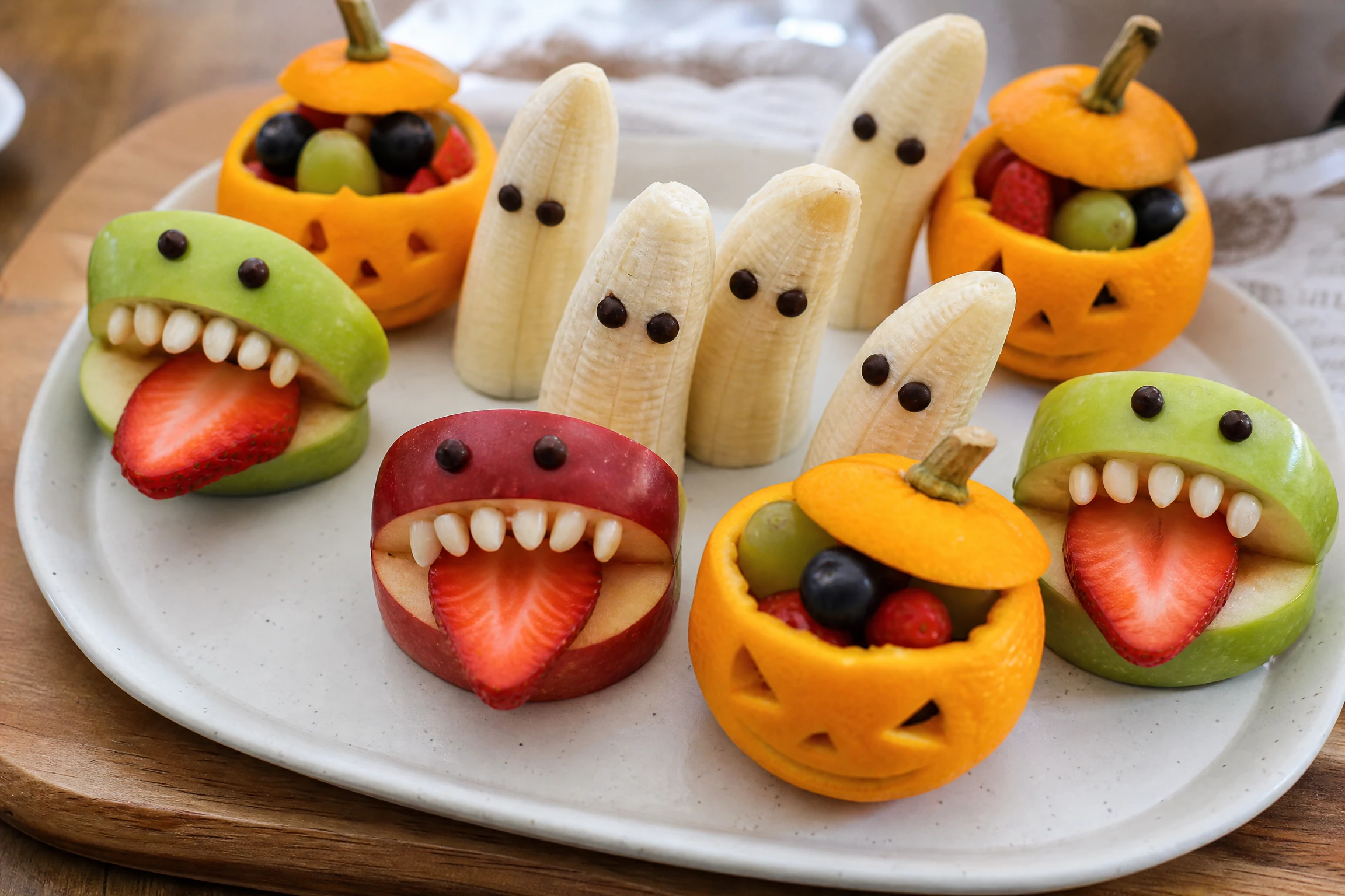 Orange pumpkin fruit cups arranged as a colorful Halloween snack